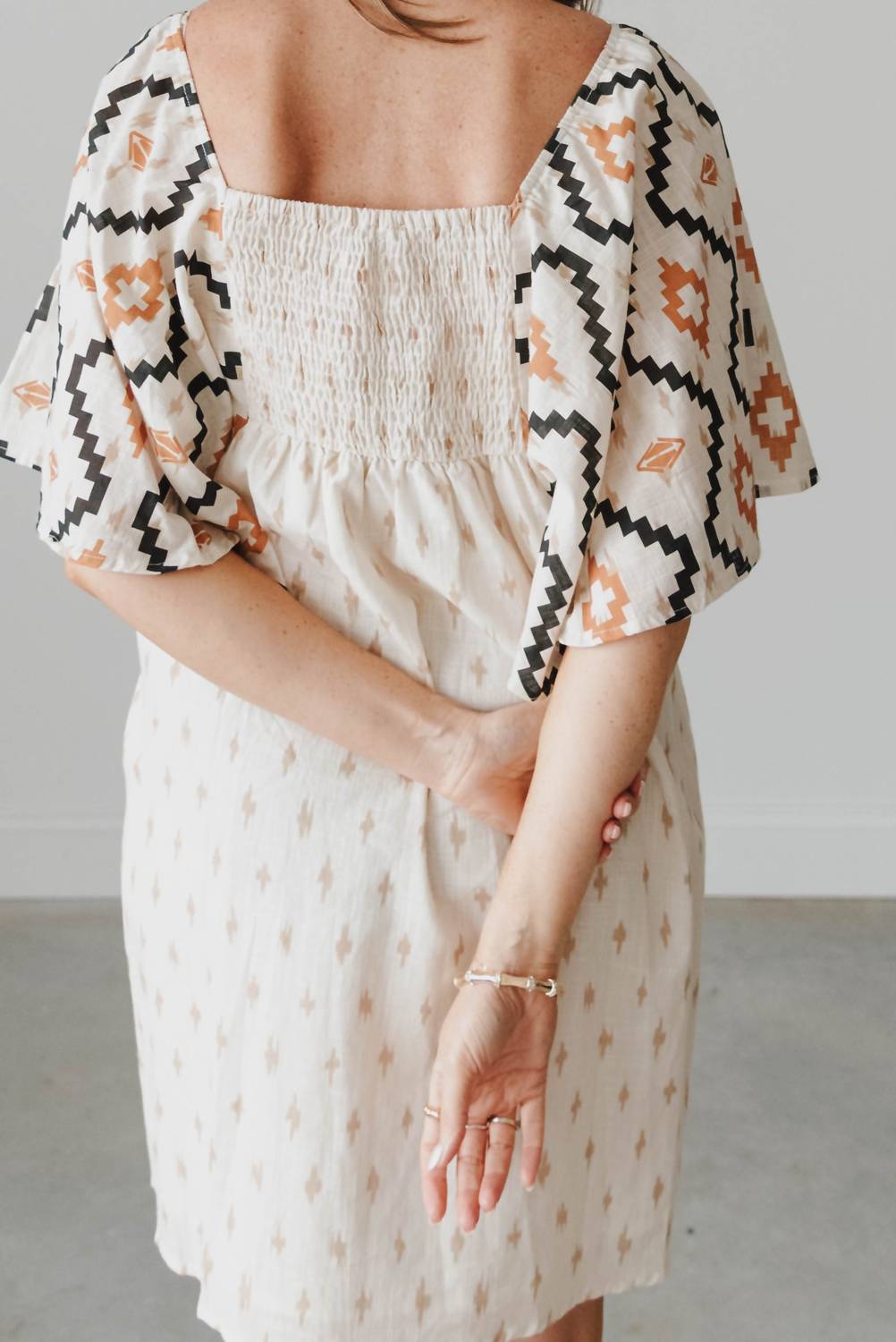 See And Be Seen - Aztec Print Pleated Square Neck Mini Dress