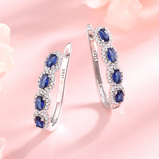 Blue & White Sapphire Halo Huggie Earrings in Sterling Silver